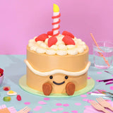 Jellycat Amuseables Birthday Cake with smiling face, candle, and strawberry decorations by Crumbs & Doilies.